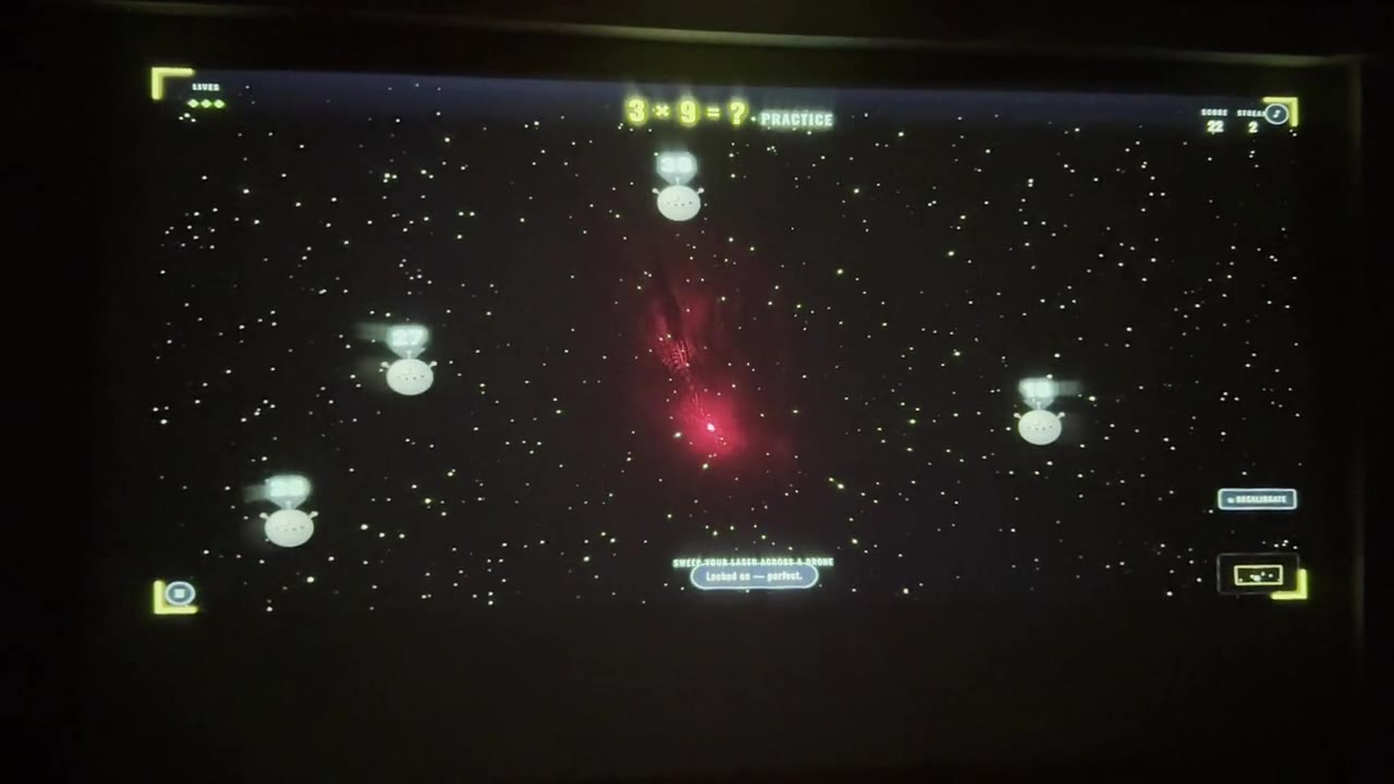 Padawan Academy multiplication game projected onto a wall with a red laser dot