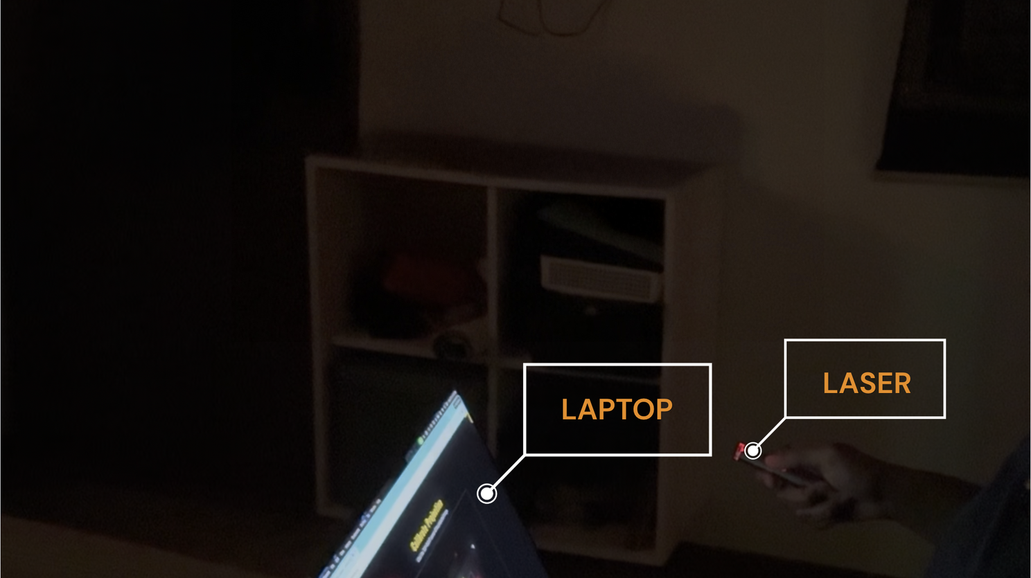 Laptop running Padawan Academy beside a person holding the laser pointer